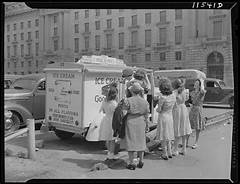 Vintage photo of guests purchasing ice cream from Good Humor Ice Cream truck.