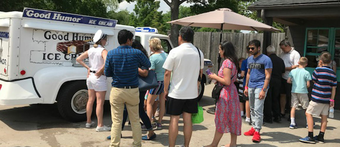 Photo of event goers purchasing ice cream from the Ol' Tyme Good Humor Ice Cream truck.