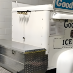 Close-up of a vintage ice cream truck with metal detailing.